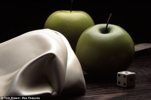 Ripe to the touch, or so it seems. These apples are some of art professor Tom Eckert's wooden creations