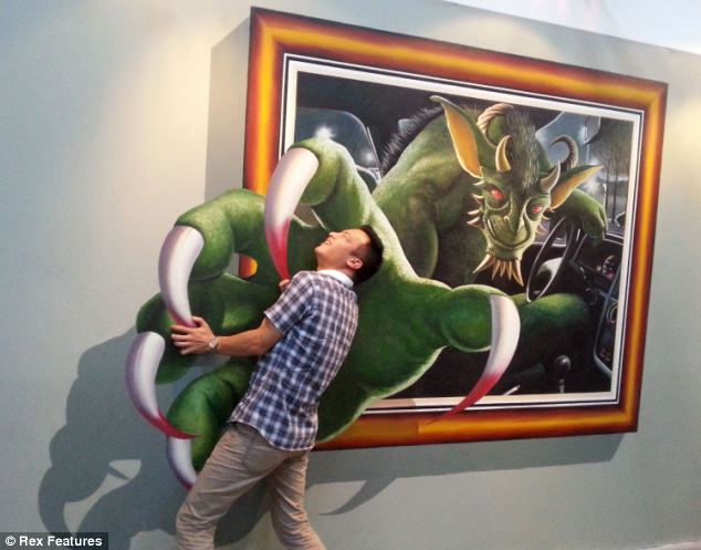 Yeouch! But thankfully it's just a 3D painting and not an actual monster pulling this man into the front seat of his car at an exhibition in Hanyang in China's Hubei Province
